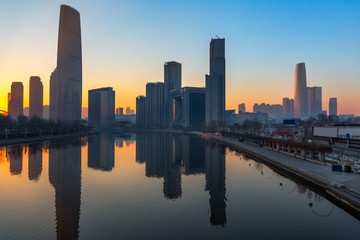 Fototapeta na wymiar River And Modern Buildings Against Sky at dusk in Tianjin,China.