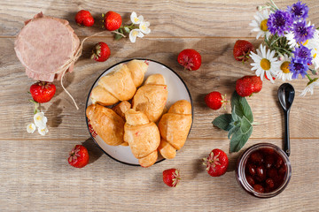 Traditional homemade strawberry jam in a jars, decorated with fresh strawberries