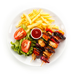 Kebabs - grilled meat and vegetables on white background 