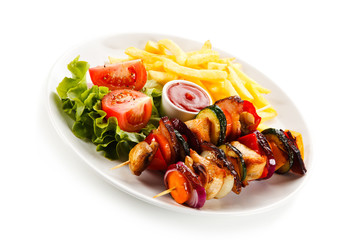 Kebabs - grilled meat and vegetables on white background 