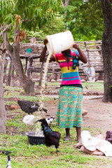 African woman preparing meal for family in the village