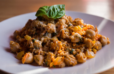 Italian Tasty Cheesy Vegetarian Pasta with Soybean Ragu Vegetables Sauce and Basil Garnish