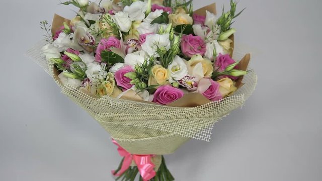 Pink roses and eustoma bouquet with bow turning