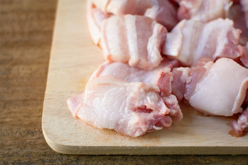 Raw pork on a cutting board wood table background