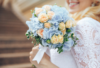 Obraz na płótnie Canvas wedding bouquet in hands of bride. Smiling bride
