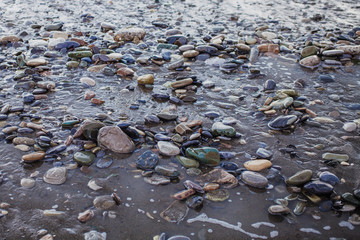 Wet pebbles and sand