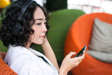 young beautiful woman listening music headphones with smartphone