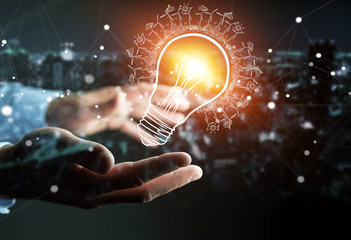 Businessman holding renewable eco lightbulb sketch