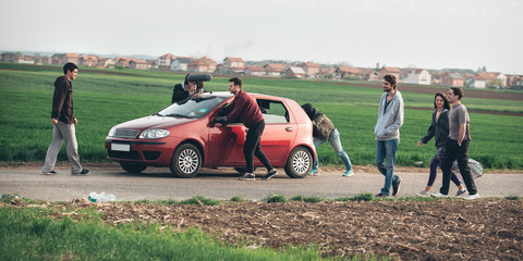 Behind scene improvisation. Film crew team pushing car with cameraman