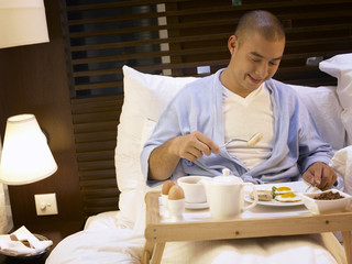 man enjoying breakfast in the hotel room