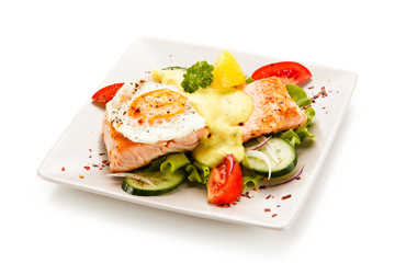 Grilled salmon with fried egg and vegetables on white background 