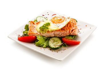 Grilled salmon with fried egg and vegetables on white background 
