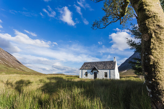White cottage at the banks of the river Coe, long exposure, Glencoe, Scotland