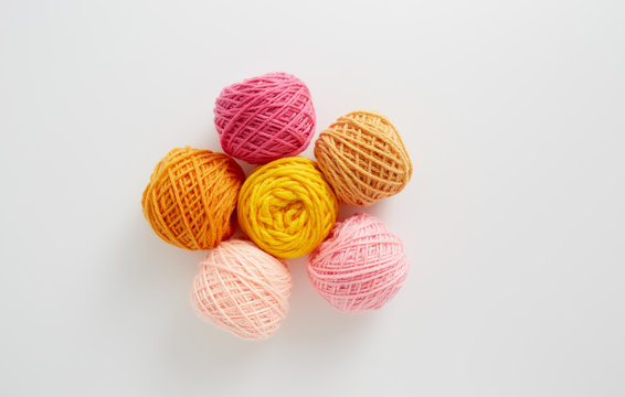 Knitting yarn balls in pink and yellow tone.