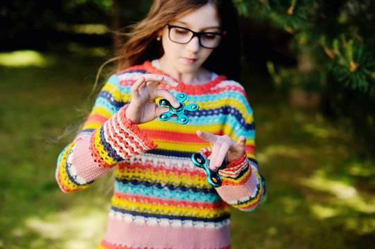 School kid playing with Hand Spinner