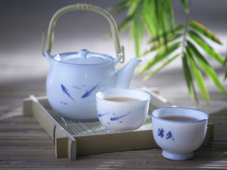 ..tea pot and cups in bamboo garden