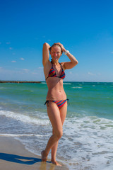 Fototapeta na wymiar Happiness Attractive girl in the sea splashing water on beach