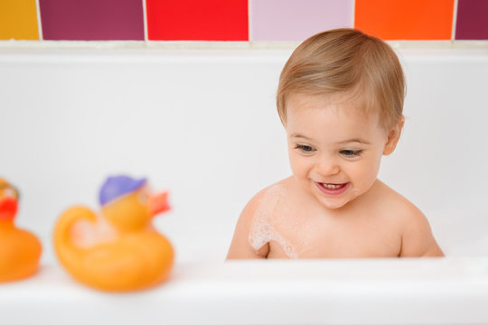 smiling toddler girl in bathtub