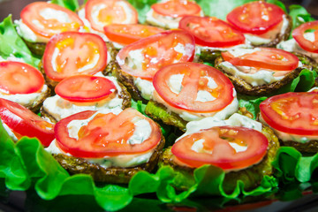 Fried zucchini with tomato with garlic sauce. Traditional Russian appetizer.