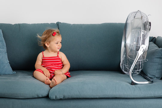 Toddler on the couch near the fan