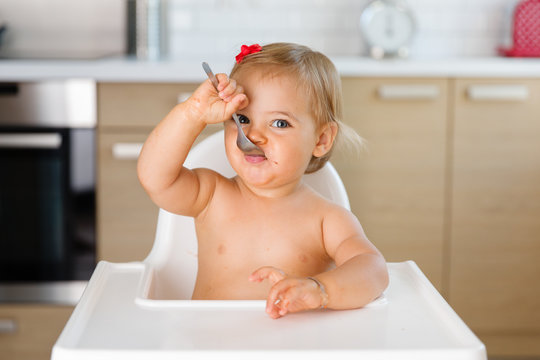 toddler eating dessert with spoon