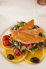 Salmon with vegetables arranged on a plate, Traditional dish in elegant setting, Selective focus with soft light