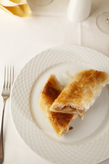Apple pie slice arranged on a plate, Traditional dessert in elegant setting, Selective focus with soft light
