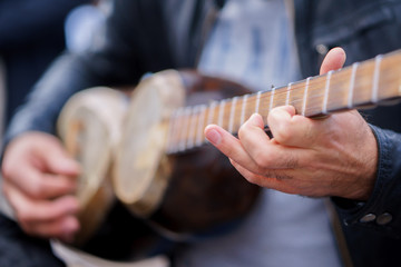 a man plays on a classical folk instrument tar of Azerbaijan