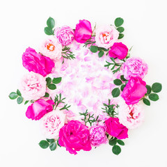 Round frame of pink roses and pink petals on white background. Flat lay, top view. Floral pattern