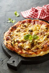 Pizza with baked meat and chili sauce