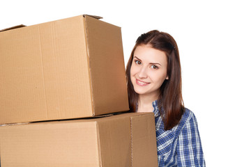 Delivery, relocation and unpacking. Closeup of xmiling young woman holding a pile of cardboard boxes