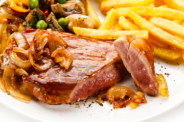 Grilled beef steak with french fries on white background 