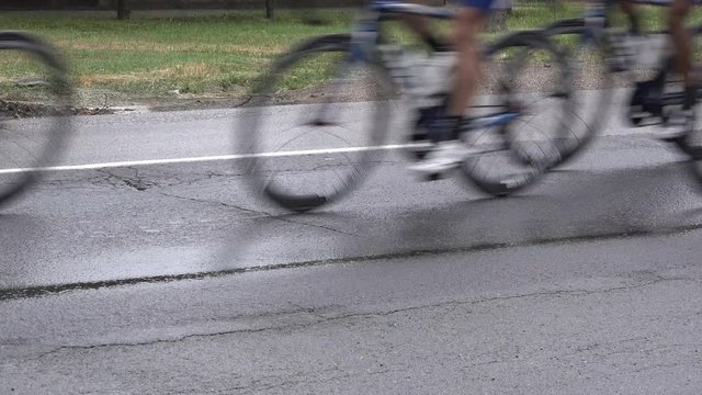 Bicycle wheels during the cycle road race, many competitors riding down the street