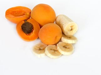 Apricot and banana on white background