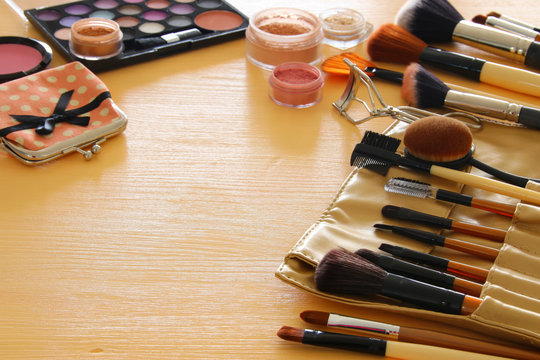 makeup cosmetics beauty tools and brushes on wooden background