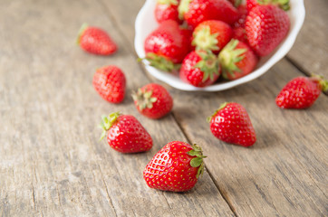 Ripe red strawberries on wooden table
