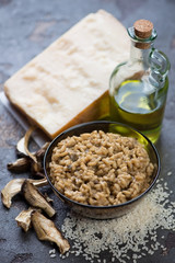 Porcini mushrooms risotto and its cooking ingredients, selective focus, vertical shot
