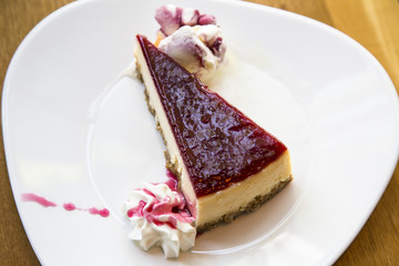 Fresh raspberry cheesecake on white plate