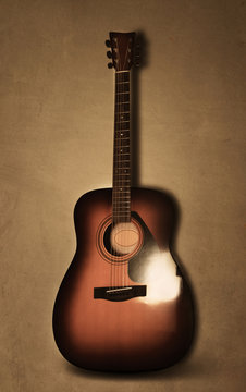 Acoustic guitar on old background texture