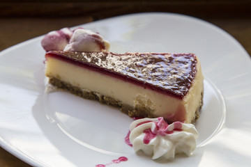 Fresh raspberry cheesecake on white plate 