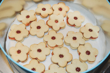 christmas biscuits with marmalade in the middle, stored in a tin - 162051556
