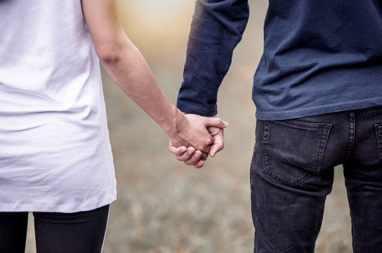 Close up view of a romantic senior couple holding hands