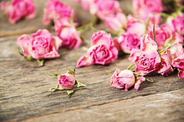 Fototapeta na wymiar dry roses on a wooden background