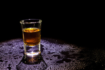 Whiskey in glass shots  on black background.