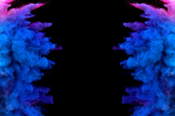 Bizarre forms of powder paint and flour combined  explode in front of a black background to give...