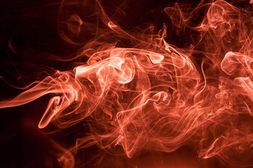 Fototapeta premium Red smoke on a black background.
