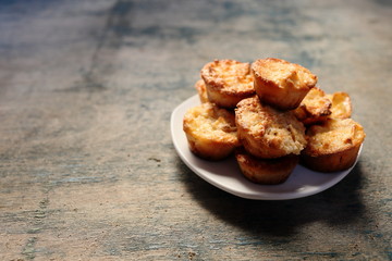 Muffins on a plate on a wooden vivid background.