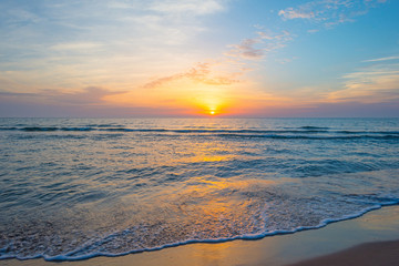 Sunrise over sea and sandy beach in spring