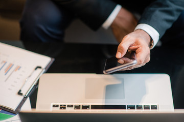 Business man work with telephone and labtop