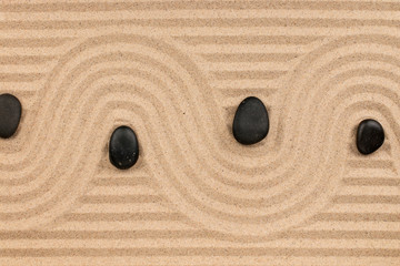 Black stones and a zigzag from the sand.